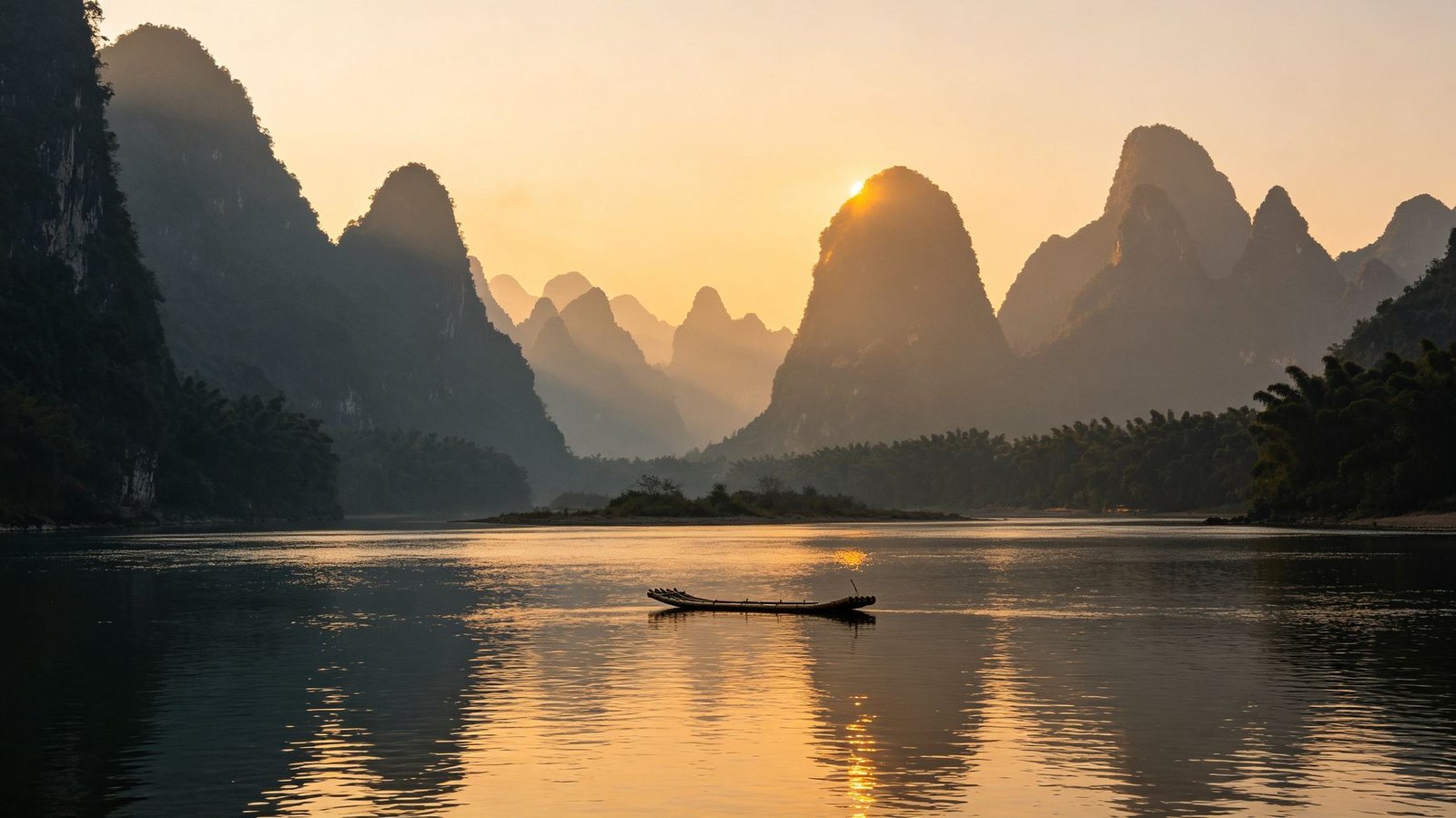 Karst mountains along the Li River near Guilin at dusk, a bamboo raft on the water