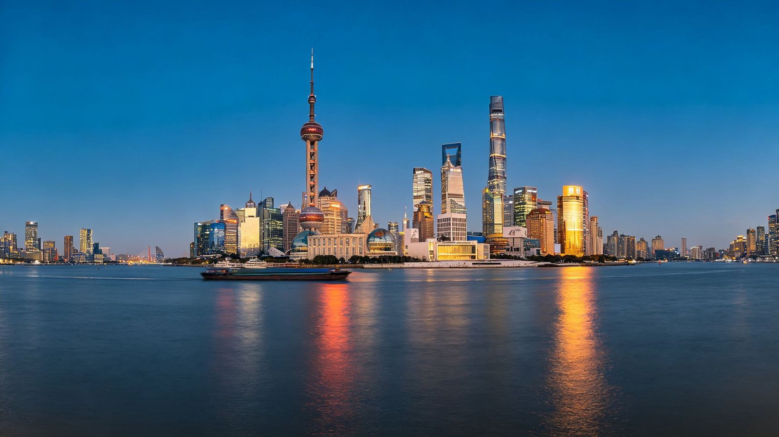 The Shanghai Bund skyline at dusk from across the Huangpu River, Pudong towers lit
